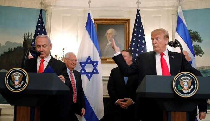 US President Donald Trump gestures next to Israel’s Prime Minister Benjamin Netanyahu during a ceremony to sign a proclamation recognising Israeli sovereignty over the Golan Heights in the Diplomatic Reception Room at the White House in Washington, US, March 25, 2019. (Reuters)