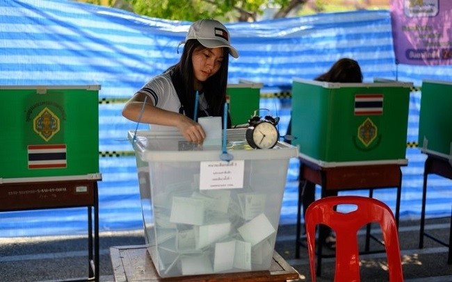 A voter casts her ballots in the March 24, 2019, election in Thailand.