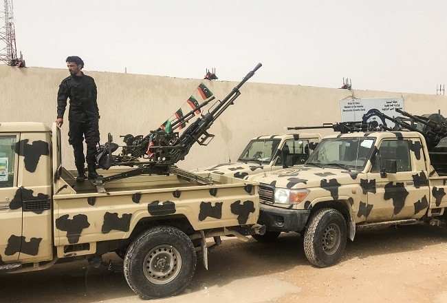 A local militiaman, belonging to a group opposed to Libyan strongman Khalifa Haftar, stands on a vehicle the group said they seized from Haftar’s forces at one of their bases in the coastal town of Zawiya, west of Tripoli on April 5, 2019, hours after Haftar’s froces were pushed back from a key checkpoint less than 30 kilometres (18 miles) from Tripoli, according to security source said. (Photo: AFP)