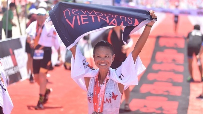A triathlete finishes the Ironman 70.3 Vietnam race in Da Nang. (Photo: Ironman Vietnam