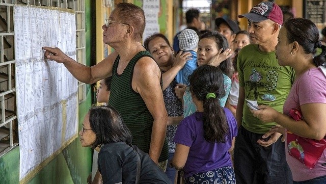 Voters in Quezon City look for their names at a polling precinct ahead of the elections on May 13. (Photo: Getty Images)