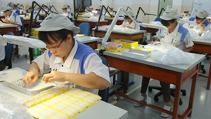 Workers of MaNi Hanoi Company at Diem Thuy Industrial Park producing dental medical equipment for export.