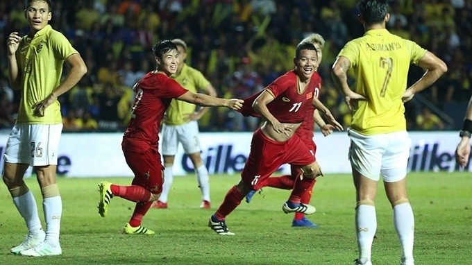 Nguyen Anh Duc (no. 11) celebrates scoring a last-gasp goal for Vietnam. 