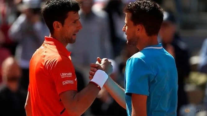 Austria's Dominic Thiem and Serbia's Novak Djokovic great each other after their semifinal match - Roland Garros, Paris, France - June 8, 2019. (Reuters)