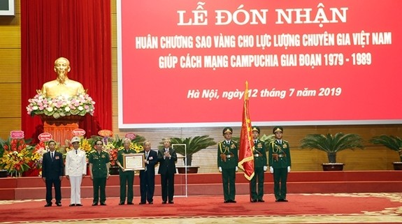 Politburo member and Permanent of permanent member of the Secretariat Tran Quoc Vuong presents the Gold Star Order to the Force of Vietnamese experts assisting Cambodian revolution during the 1979-1989 period. (Photo: qdnd.vn)