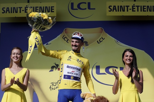 Cycling - Tour de France - The 200-km Stage 8 from Macon to Saint-Etienne - July 13, 2019 - Deceuninck-Quick Step rider Julian Alaphilippe of France celebrates on the podium, wearing the overall leader's yellow jersey. 