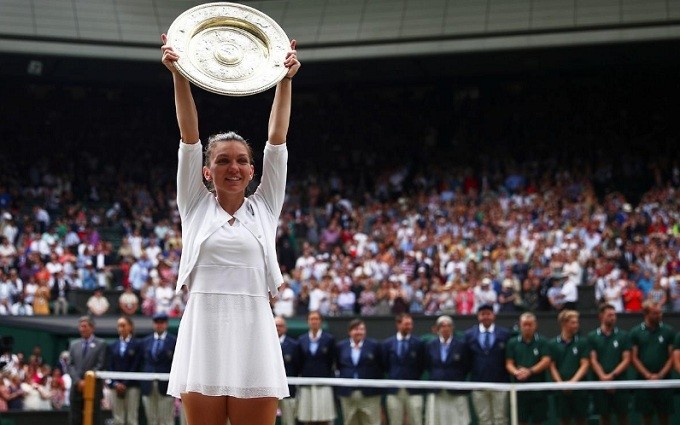 Tennis - Wimbledon - All England Lawn Tennis and Croquet Club, London, Britain - July 13, 2019 Romania's Simona Halep poses with the trophy as she celebrates after winning the final against Serena Williams of the US. (Reuters)