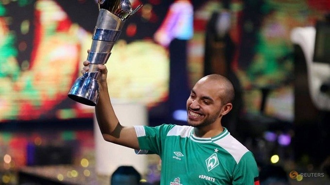 Esports - FIFA eWorld Cup Grand Final 2019 - O2 Arena, London, Britain - August 4, 2019 Mo Harkous (MoAuba) of Germany celebrates with the trophy after winning the FIFA eWorld Cup 2019. (Reuters)