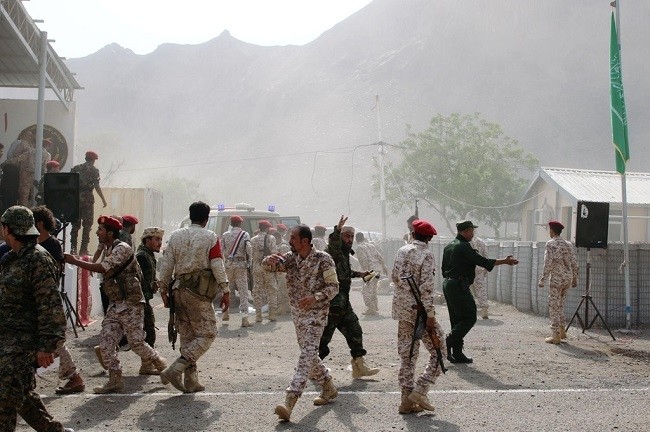 Soldiers rush to help the injured following a missile attack on a military parade in Aden. (Photo: Reuters)