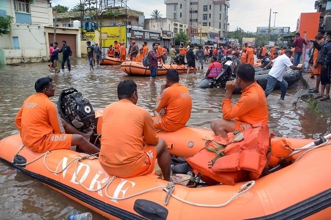 National Disaster Response Force (NDRF) rescue team check for the flood situation, as floodwaters have receded, at Sangli, Maharashtra, on August 11. (Source: AFP)