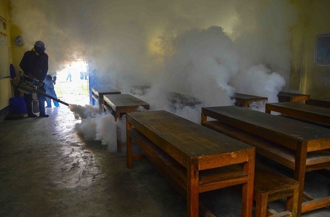 A man fumigates a classroom in south Okkalapa Township. (File photo: Global New Light of Myanmar)