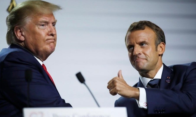 French President Emmanuel Macron and US President Donald Trump react during a news conference at the end of the G7 summit in Biarritz, France, August 26, 2019. (Reuters)