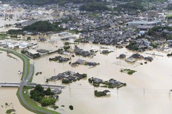 An aerial view shows submerged houses and facilities at a flooded area in Takeo, Japan. (Photo: Yahoo News UK)