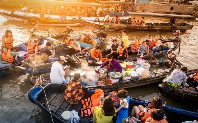 People trade goods at the Cai Rang floating market on the Hau River.
