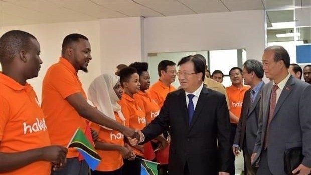 Vietnamese Deputy Prime Minister Trinh Dinh Dung (second, right) meets with employees of the Vietnamese-invested Halotel company during his visit to Tanzania in July (Photo: VNA)