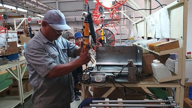 Manufacturing agricultural machinery at the Southern Vietnam Engine And Agricultural Machinery Company Limited (Photo: Nguyet Bac)