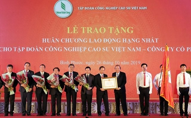Deputy Prime Minister Truong Hoa Binh (far right) presents the First-Class Labour Order to the Vietnam Rubber Group. (Photo: NDO/Nhat Son)