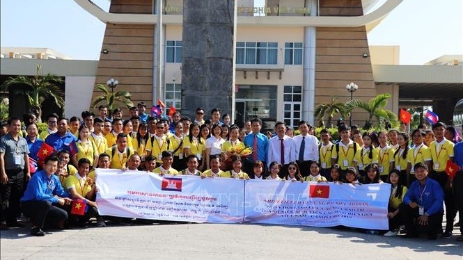 The delegates take a photo at Moc Bai International Border Gate in Tay Ninh province. (Photo: VNA)