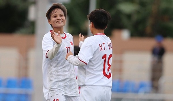 Nguyen Thi Van (R) celebrates scoring a goal for Vietnam. 
