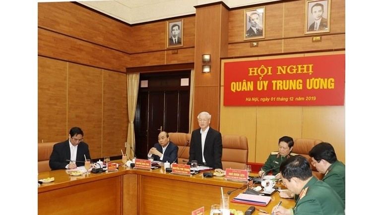 Party General Secretary, President and Secretary of the Central Military Commission Nguyen Phu Trong (standing) chairs the commission's meeting in Hanoi on December 1. (Photo: VNA)