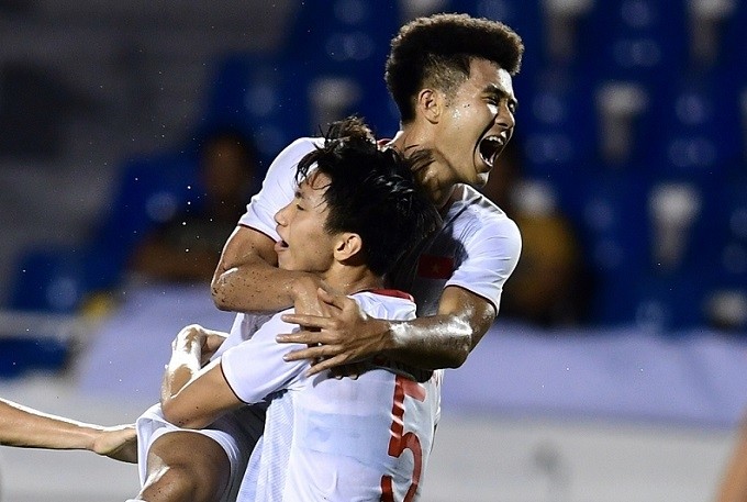 Ha Duc Chinh celebrates with Van Hau (no. 5) after scoring a late winner for Vietnam during their Group B match against Singapore on December 3.