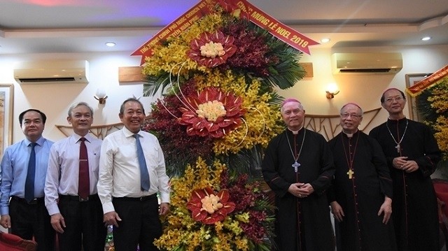 Deputy Prime Minister Truong Hoa Binh (third from left) presents a flower basket from Prime Minister Nguyen Xuan Phuc to the dignitaries of Xuan Loc Diocese to celebrate Christmas this year . (Photo: NDO/Thien Vuong)