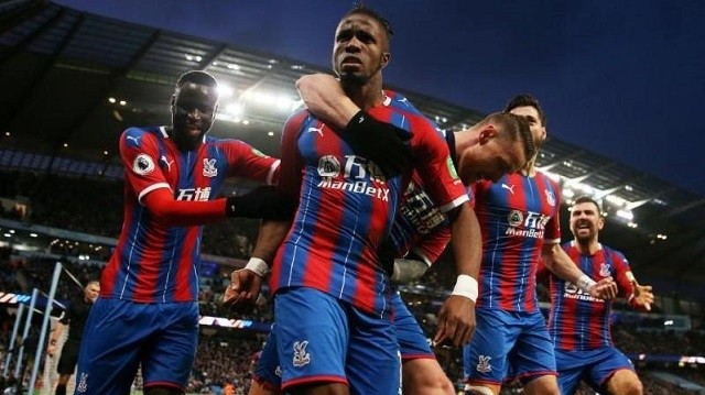 Soccer Football - Premier League - Manchester City v Crystal Palace - Etihad Stadium, Manchester, Britain - January 18, 2020 Crystal Palace's Wilfried Zaha celebrates with teammates after Manchester City's Fernandinho scored an own goal and Crystal Palace's second. (Photo: Action Images via Reuters)