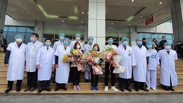 Three Covid-19 patients discharged from the National Hospital of Tropical Diseases in Hanoi on February 10, 2020. (Photo: NDO/Lam Ngoc)