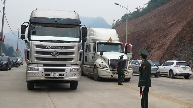Agricultural produce trucks at the Tan Thanh border gate