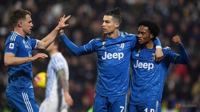 Soccer Football - Serie A - SPAL v Juventus - Paolo Mazza, Ferrara, Italy - February 22, 2020 Juventus' Cristiano Ronaldo celebrates scoring their first goal with Juan Cuadrado. (Reuters)