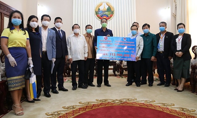 The Vietnamese community in Laos present US$13,000 to the Lao government on April 10 to support the country’s fight against COVID-19. (Photo: NDO)