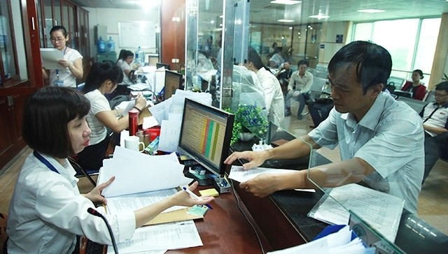 Enterprises carry out procedures of business registration through the one-door system at the Hanoi municipal Department of Planning and Investment. (Photo: ND)