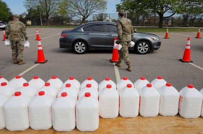 Members of the Massachusetts Army National Guard distribute free milk, offered instead of dairy farmers throwing away excess milk due to lower demand amid the Covid-19 outbreak, in Boston, Massachusetts, May 7, 2020. (Photo: Reuters)