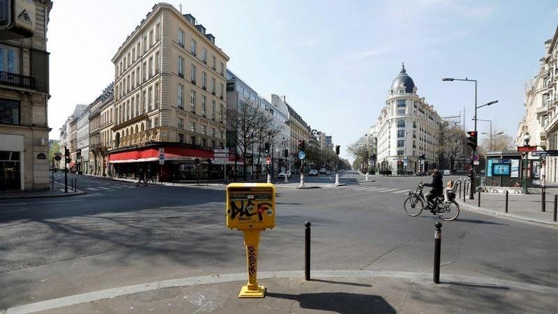 A cyclist rides on the deserted Grands Boulevards in Paris as a lockdown is imposed to slow the rate of the coronavirus disease (COVID-19) in France, March 27, 2020. (Photo: Reuters)