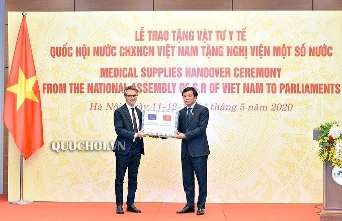 General Secretary of the Vietnamese National Assembly Nguyen Hanh Phuc (R) hands over medical supplies to Ambassador Pier Giorgio Aliberti, head of the EU Delegation to Vietnam. (Photo: quochoi.vn)