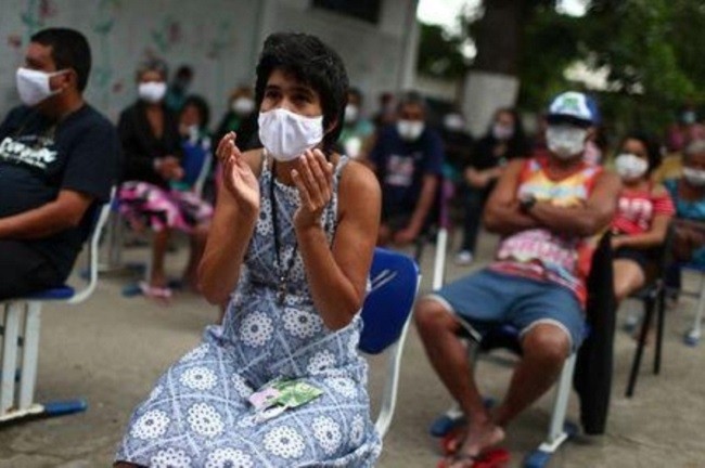 A resident of the shelter Stella Maris Complex for elderly people, homeless and patients with mental disorders managed by the Rio de Janeiro City Hall wears a protective face mask as she reacts, amid concerns of the spread of the coronavirus disease (COVID-19), in Rio de Janeiro, Brazil May 14, 2020. (Photo: Reuters)