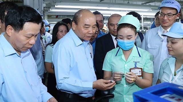 PM Nguyen Xuan Phuc asks after workers at Foster Electric Bac Ninh. (Photo: VNA)