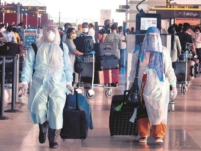 Passengers in protective gear at Delhi International Airport on May 25. (Photo: Business Standard).