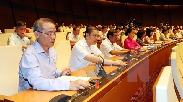 Deputies cast votes at the ongoing ninth sitting of the 14th National Assembly (NA) in Hanoi on June 8. (Photo: VNA)