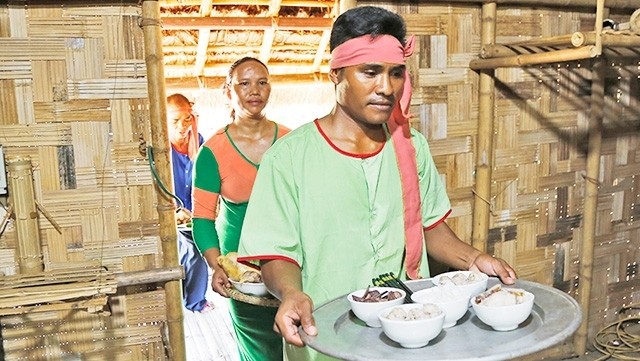 A couple prepare a meal for the ceremony