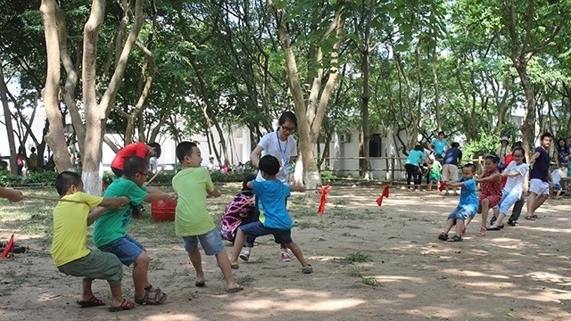 Children playing tug of war at the Vietnam Museum of Ethnology.