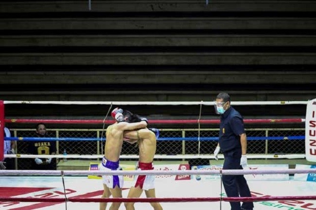 Muaythai boxers fight in front of empty spectator seats behind closed doors due to the spread of the coronavirus disease at Siam Boxing Stadium in Samut Sakhon on July 4. (Photo: Reuters)