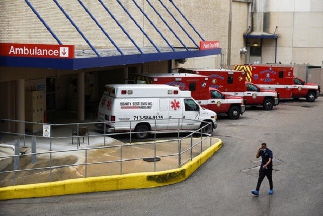 A medical worker walks past a row of ambulances parked outside Houston Methodist Hospital on June 22. The hospital is treating a current surge of COVID-19 cases. (Photo: Reuters)