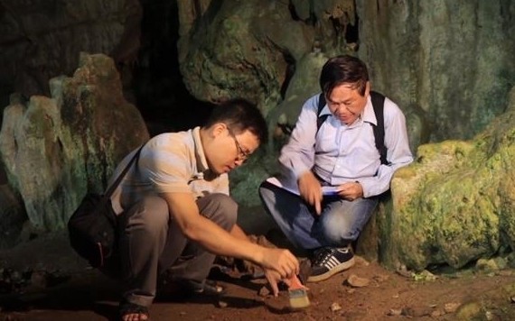 Archaeologists working inside a cave in the Ba Be National Park