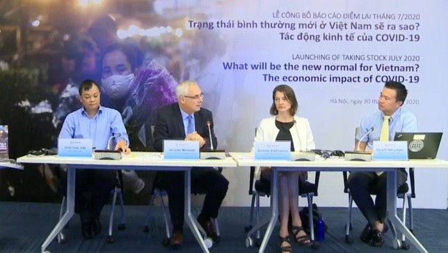 Experts at a ceremony to unveil the WB’s report "What will be the new normal for Vietnam" on July 30.