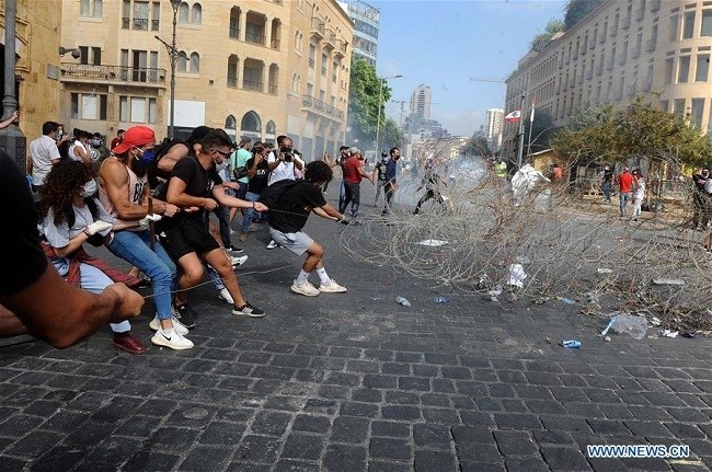 Protesters try to storm the parliament building in downtown Beirut, Lebanon, on Aug. 8, 2020. (Photo: Xinhua)