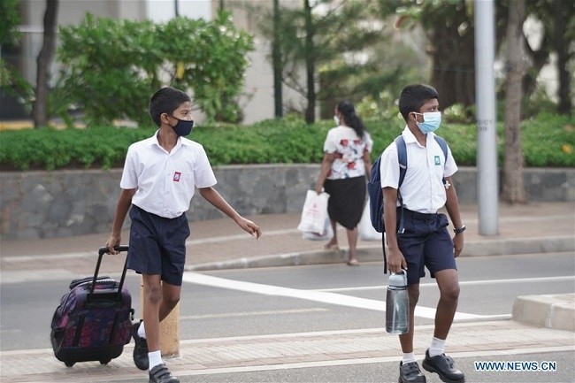 Students walk to their school in Colombo, Sri Lanka, on Aug. 10, 2020. All state-owned schools across Sri Lanka re-opened on Monday after being shut for over a month amid the COVID-19 pandemic which has infected more than 2,800 people in the island country, the Education Ministry said. (Photo: Xinhua)