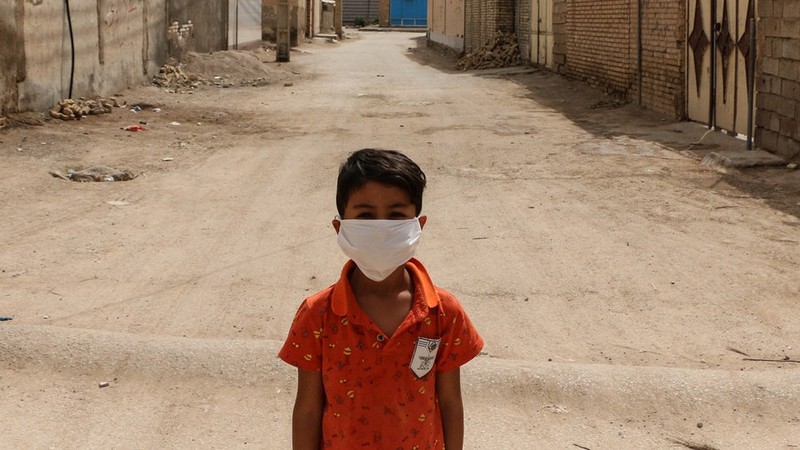 A boy stands in a disadvantaged neighbourhood of Ahvaz, Iran. The country is among those being subjected to international sanctions, despite the ravages of COVID-19. (Photo: news.un.org)