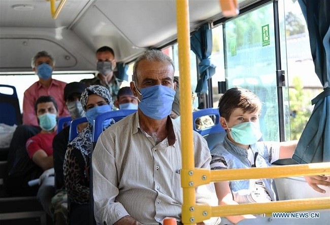  Syrians wearing facial masks take public transportation in Damascus, capital of Syria, Aug. 9, 2020. (Photo: Xinhua)