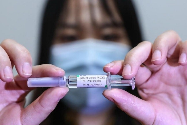 A staff member displays a sample of the COVID-19 inactivated vaccine at a vaccine production plant of China National Pharmaceutical Group Co., Ltd. (Sinopharm) in Beijing, capital of China, April 10, 2020. (Photo: Xinhua)